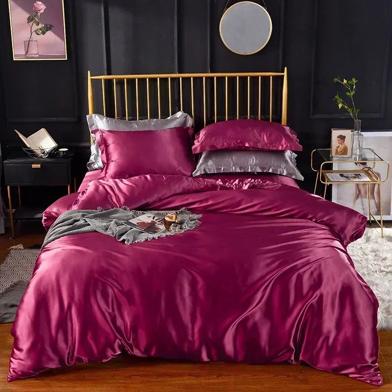 Housse de couette en satin rose framboise sur un lit, avec taies assorties et taies grises