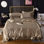 Housse de couette en satin taupe doré sur un lit, vue de face avec taies d'oreiller assorties